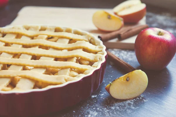 Traditional homemade apple pie and ingredients on wooden backgro — Stock Photo, Image