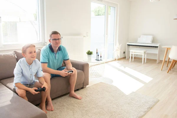 Felice giovane padre e suo figlio giocare ai giochi per computer con con — Foto Stock