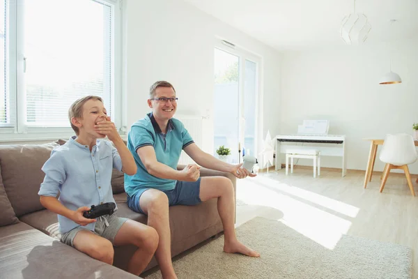 Happy young father and  his son playing computer games  with con — Stock Photo, Image