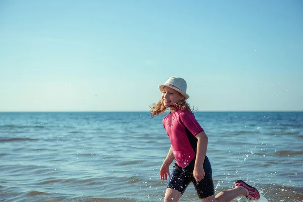 幸せなかなりティーン女の子でネオプレン水着遊びと実行でバルト海 — ストック写真