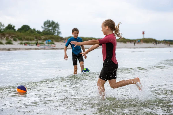 Two Happy Siblings Children Playing Jumping Ball Water Neoprene Suits — Stock Photo, Image