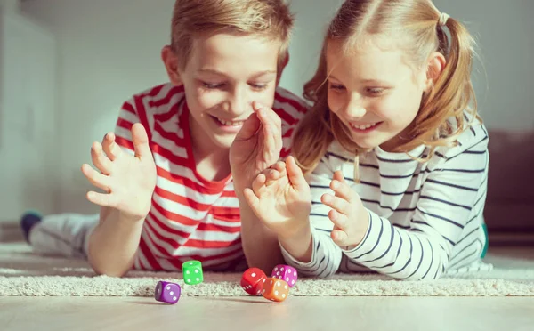 Retrato Duas Crianças Alegres Deitadas Chão Brincando Emocionalmente Com Dados — Fotografia de Stock