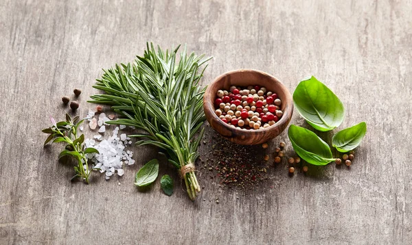 Herbs and spices on wooden board — Stock Photo, Image