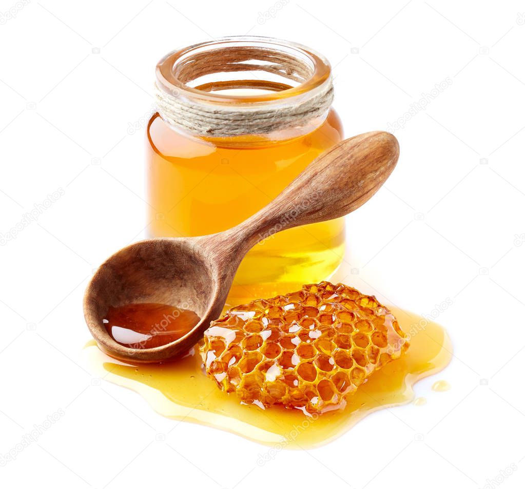 Honey with honeycomb on white