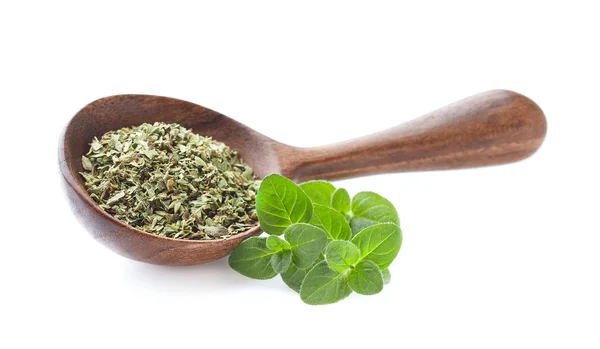 Dried oregano in wooden spoon on white — Stock Photo, Image