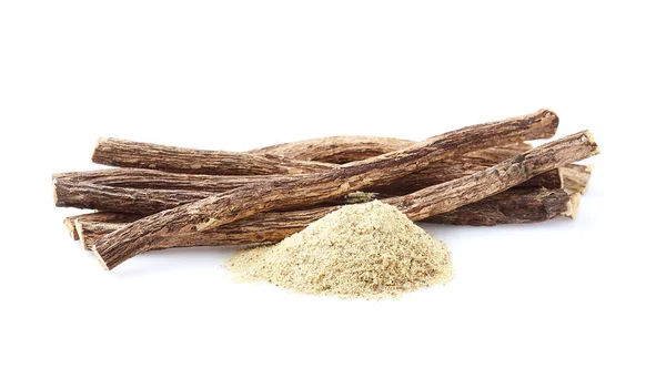 Licorice root with powder on white background — ストック写真