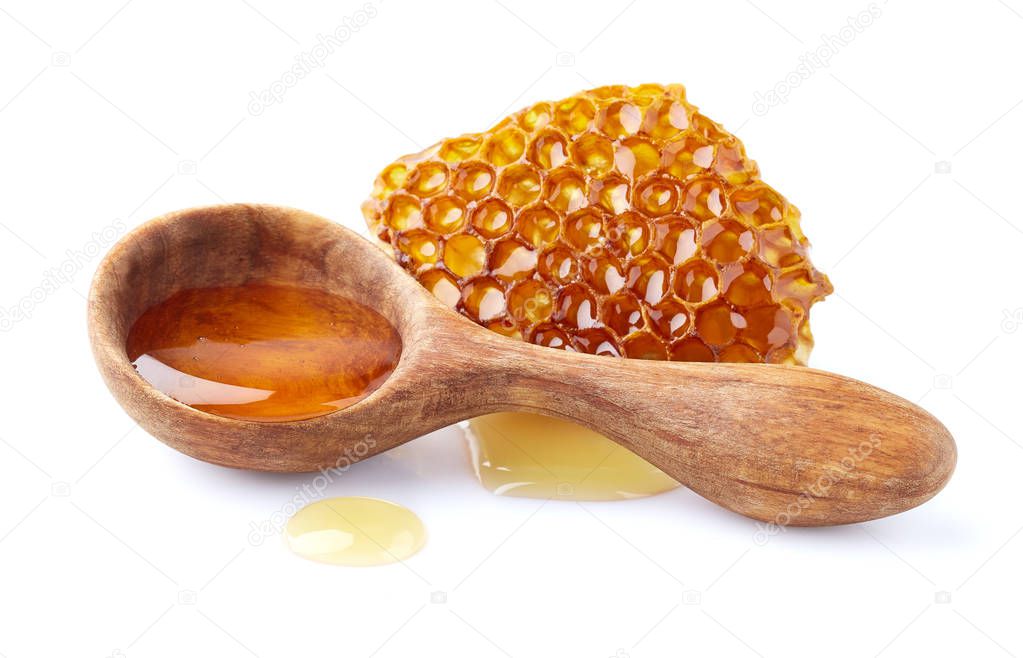 Honeycomb with honey in wooden spoon 