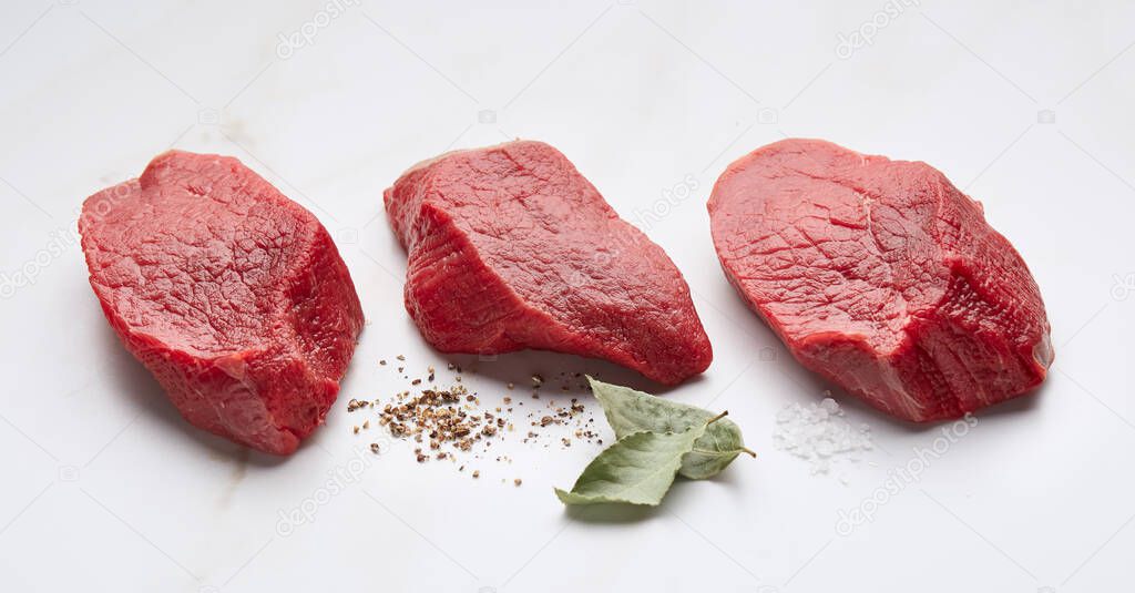 Beef mignon on white marble background