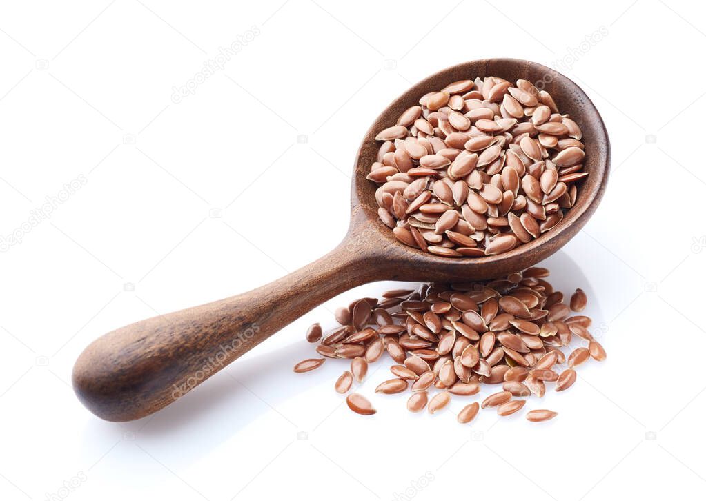 Flax seeds in wooden spoon on white background