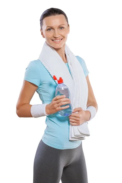 A sportswoman with white cotton towel standing smiling holding b — Stock Photo, Image