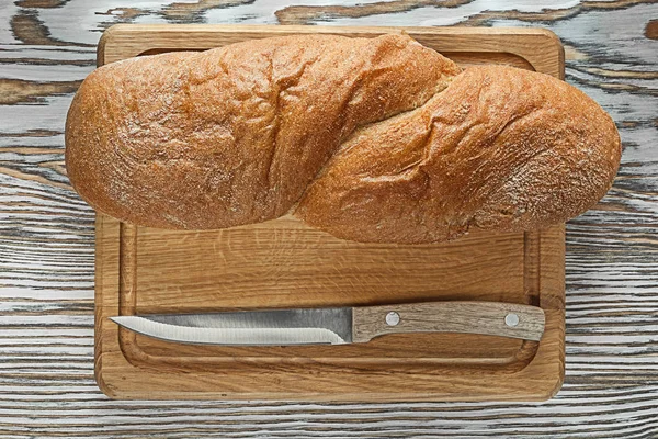 Carving board long loaf knife on vintage wooden surface
