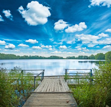 beautiful view from vintage wooden pier on big lake in forest bl clipart
