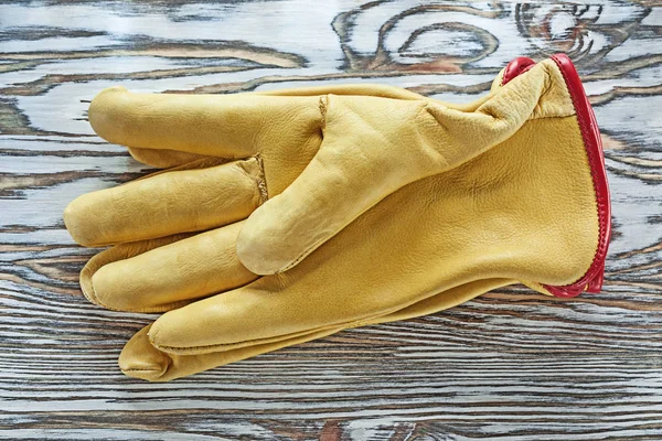 Safety gloves on wooden board