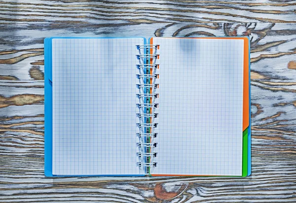 Checked notepad on wooden board — Stock Photo, Image