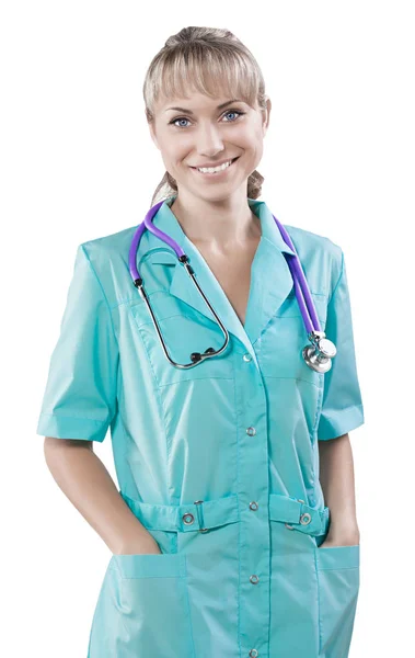 A smiling caucasian young female doctor with hands in pockets lo — Stock Photo, Image