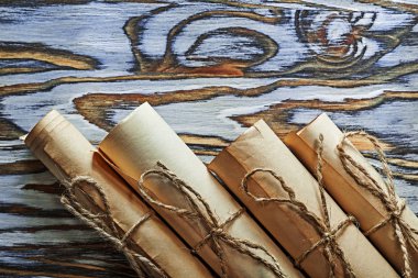 Vintage rolled paper scrolls on wooden board clipart