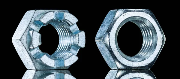 Stainless crown nuts on black background — Stock Photo, Image