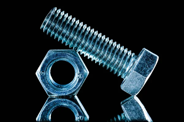 Construction nut screwbolt on black background — Stock Photo, Image