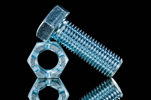 Threaded crown nuts bolts on black background horizontal view — Stock Photo, Image