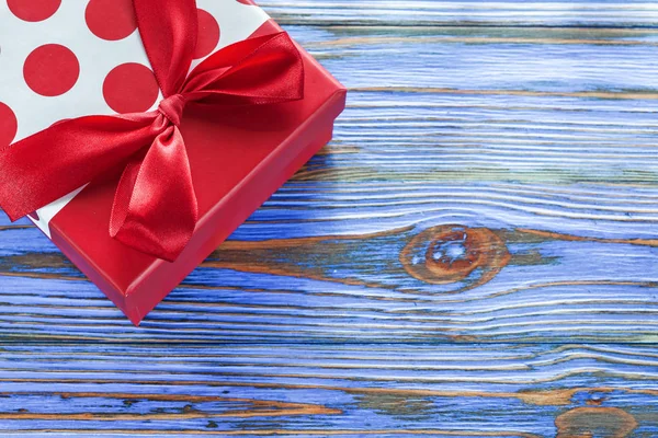 Red boxed present on vintage wooden board — Stock Photo, Image