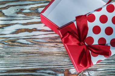 Antika ahşap tahta üzerinde yay ile kırmızı hediye kutusu