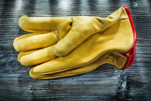 Safety gloves on vintage wooden board.