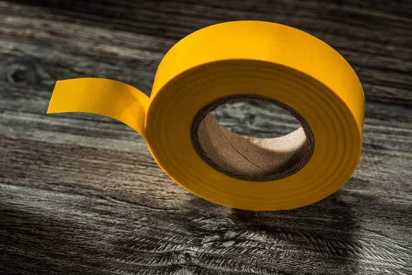 Rolled Yellow Insulation Tape Wooden Board — Stock Photo, Image