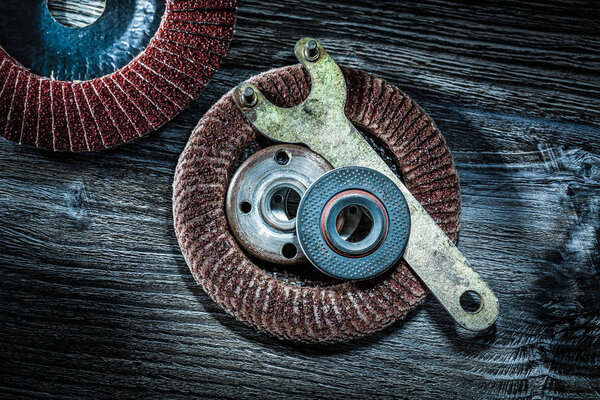 Round polishing discs abrasive key on wooden board.