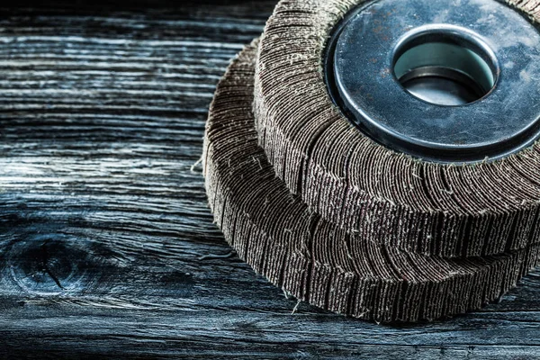 Used polishing flap wheels on vintage wooden board.