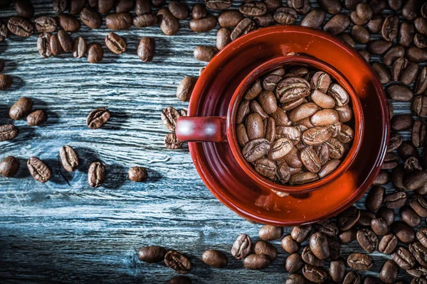 Coffee crops cup saucer on wooden board.