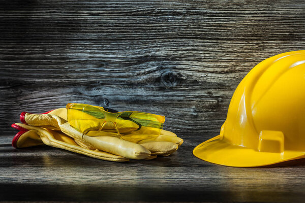 safety glasses on working gloves and helmet