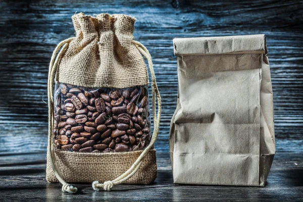 beans of coffee in sack and paper bag