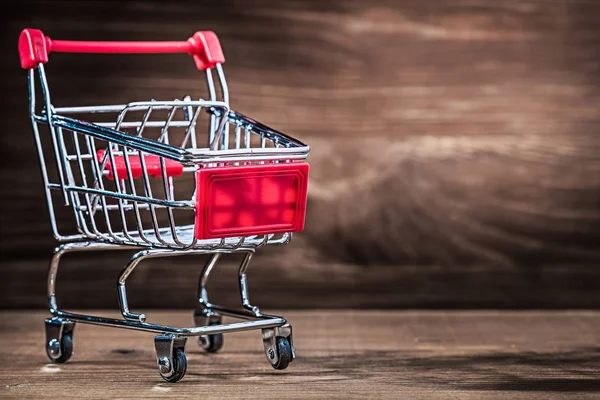 model of shopping cart on vintage wood with copyspace