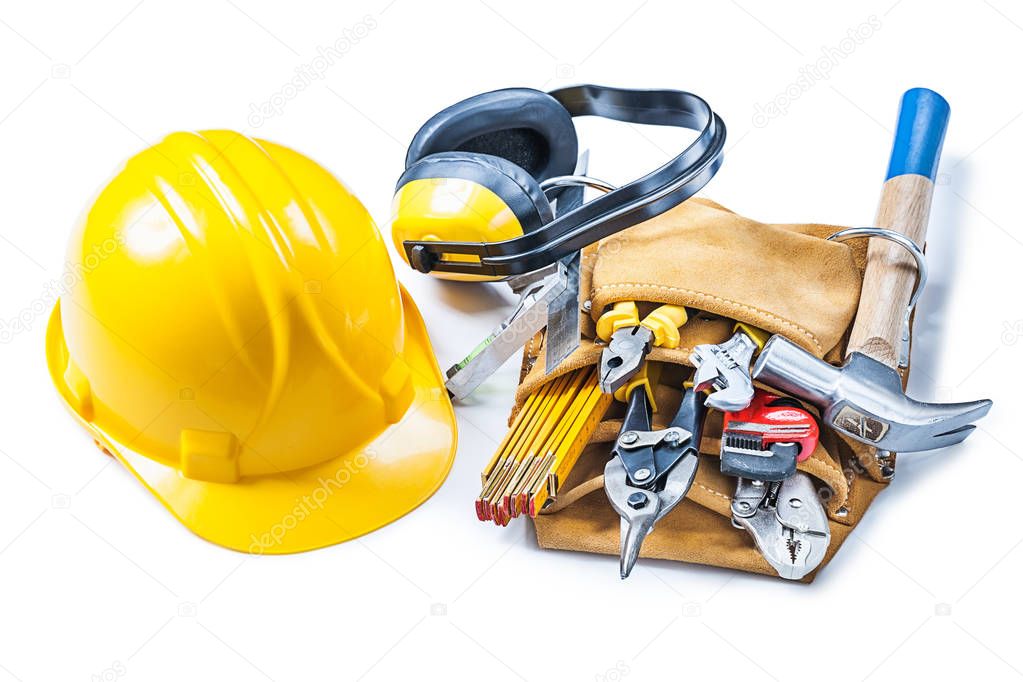 helmet earphones and toolbelt with construction tools isolated o