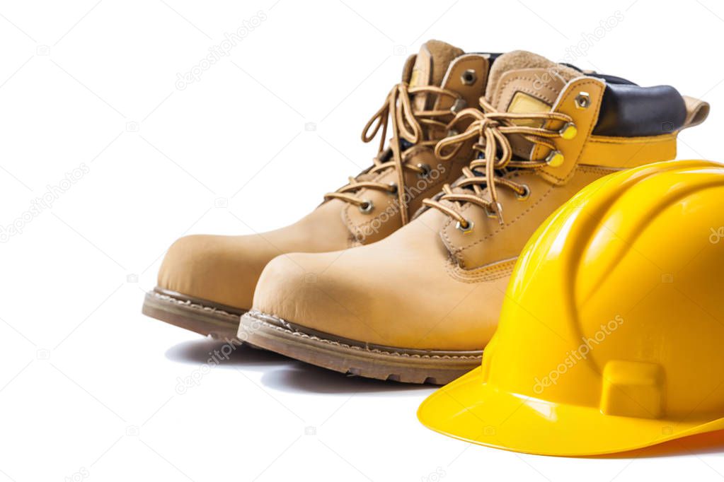 pair of working boots and yellow helmet isolated on white