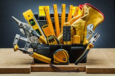 tool box wirh many construction tools on wood boards clipart