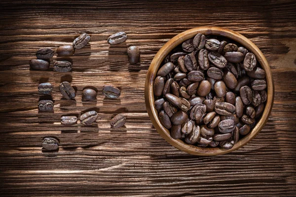 Coffee crops bowl on vintage wooden board — Stock Photo, Image