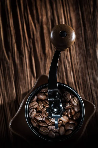 Café moinho de grãos naturais na placa de madeira vintage — Fotografia de Stock