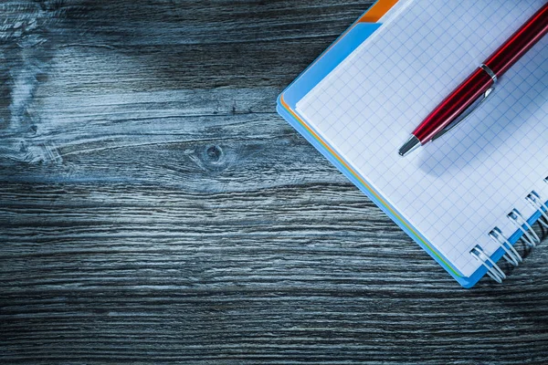 Spiral notebook pen on wooden board — Stock Photo, Image