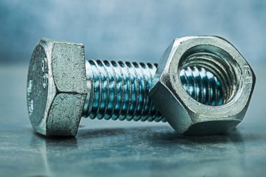 cıvata ve somun Metalik arka plan üzerinde