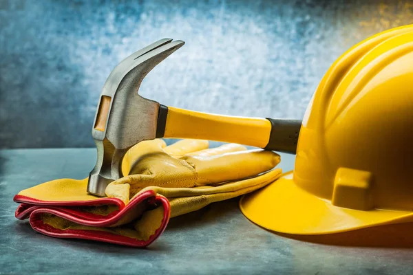 Garra martillo construcción guantes de cuero y casco amarillo en met —  Fotos de Stock