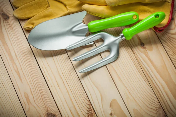 Hand spade en vork met handschoenen op hout. Tuingereedschap. — Stockfoto
