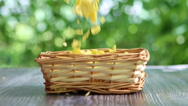 Corn Flakes Falling Wickered Bowl Standing Table Garden Slow Motion — Stock Video