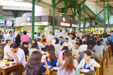 SINGAPORE - JANUARY 16, 2017 : People eating at popular food court in Singapore clipart