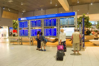 FRANKFURT, AIRPORT - AUGUST 29, 2018: People at departure hall at the Frankfurt International Airport. The airport has two passenger terminals with a capacity of approximately 65 million passengers per year clipart