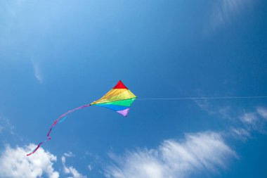 Kite flying in the sky among the clouds clipart
