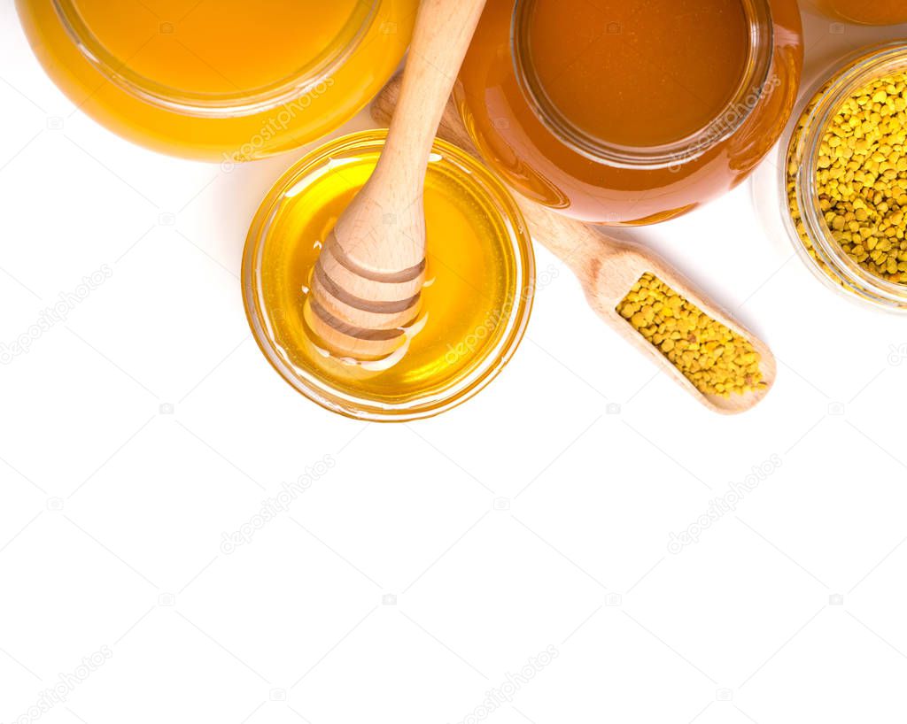 honey dipper and honey in jar on white background