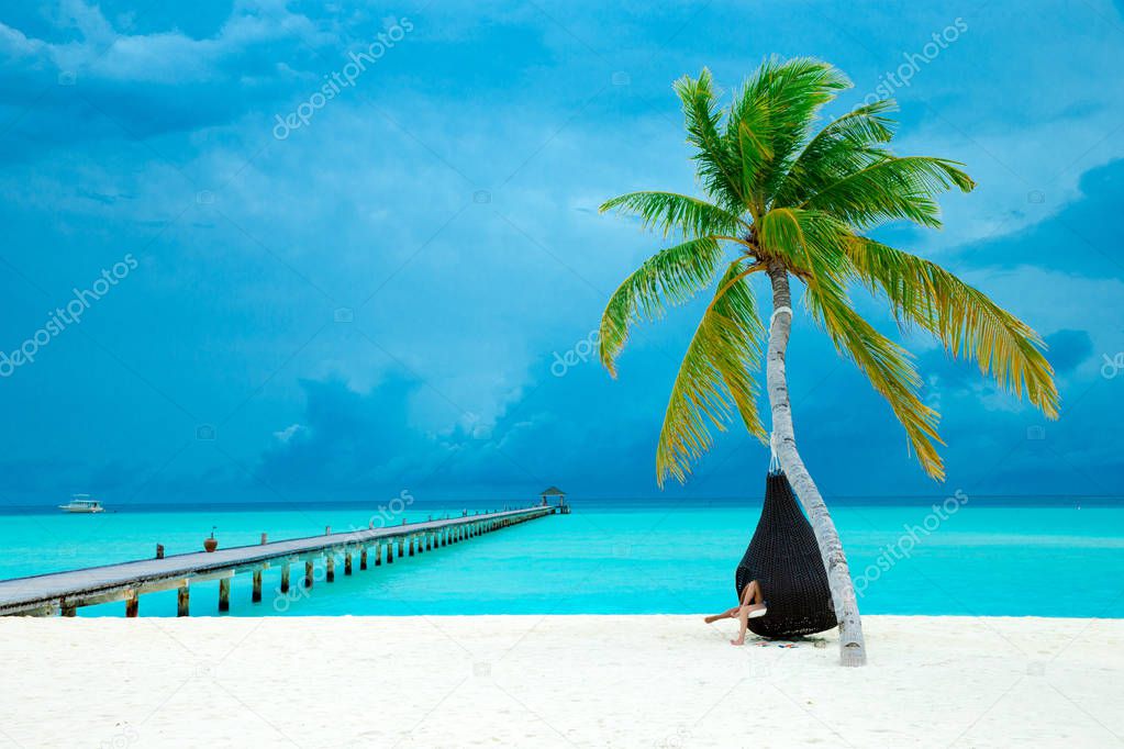 tropical Maldives island with white sandy beach and sea