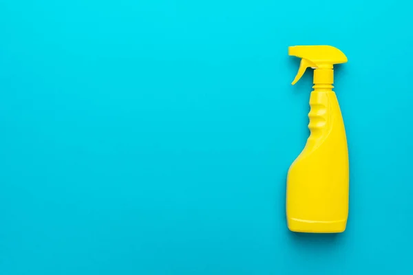 Flat lay image of yellow plastic dispenser on blue background with copy space — Stock Photo, Image
