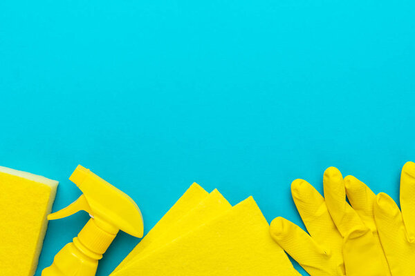 flat lay image of yellow cleaning products with copy space